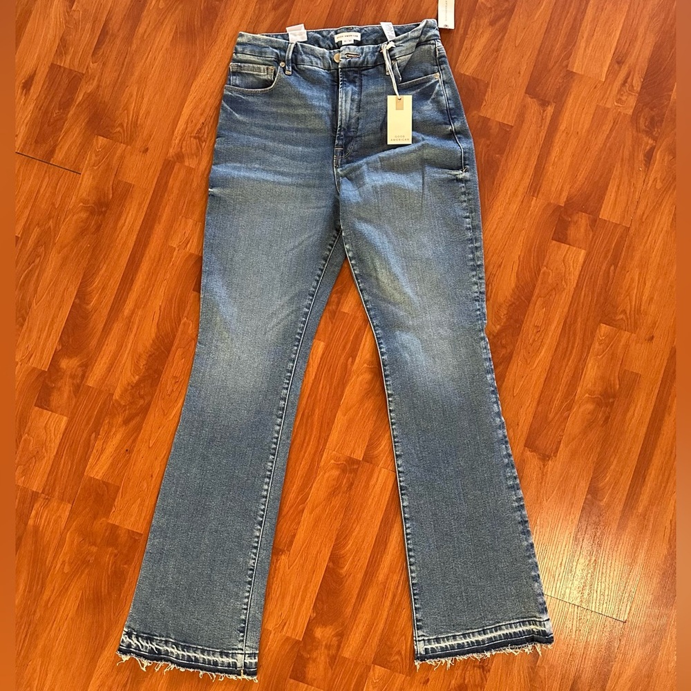 Good American flare raw hem jeans.
